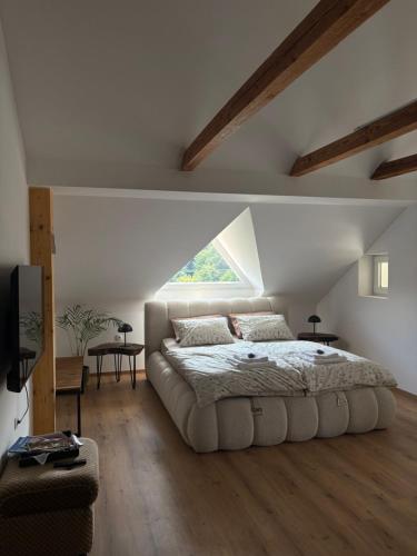 a bedroom with a large bed and a window at Apartma Lavanda in Zavrč