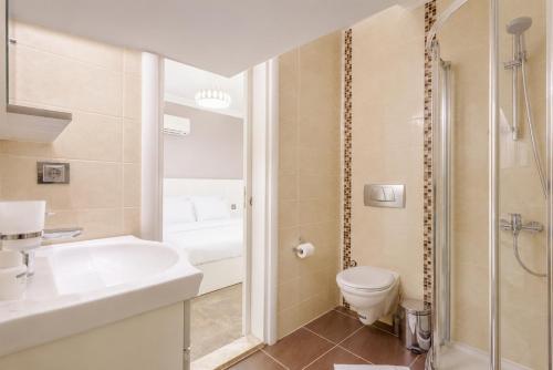 a bathroom with a sink and a toilet and a shower at Villa Ozcelik in Dalyan