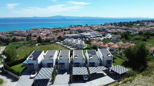 an aerial view of a city with houses and the ocean at Villa Mare 3 - Private Pool, Sea View in Hanioti