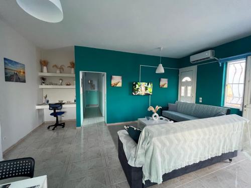 a living room with a bed and a couch at Bella's House in Theologos