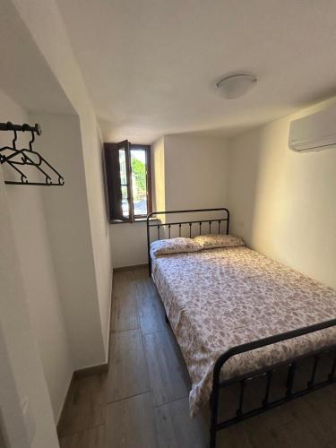 a bedroom with two beds and a window at LA CASETTA di AURORA in Riomagno