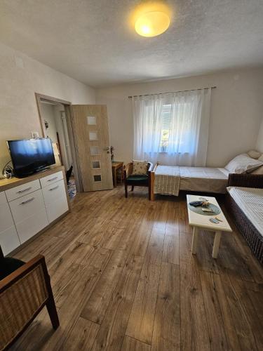 a living room with a couch and a table at Apartman sunny green in Sveti Juraj