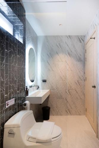 a bathroom with a toilet and a sink at April Pool Day Villa Cha-am in Cha Am