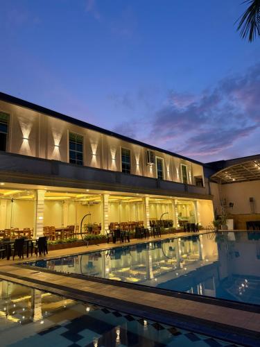 a hotel with a swimming pool in front of a building at The Lamendriea Hotel in Kalagedihena