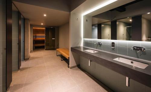 a bathroom with two sinks and a bench in it at Large Luxurious Studio, Dublin18 in Dublin