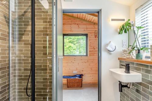 a bathroom with a shower and a sink at 4 Bed in Bugle oc-f34175 in Penwithick