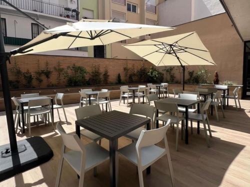 a patio with tables and chairs and umbrellas at ibis budget Logroño Centro in Logroño