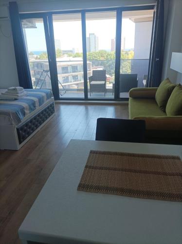 a living room with a couch and a table at Stefan - apartament studio in Saturn