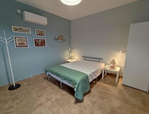 a bedroom with a bed and a lamp in it at Mosaic house by the sea in Kini