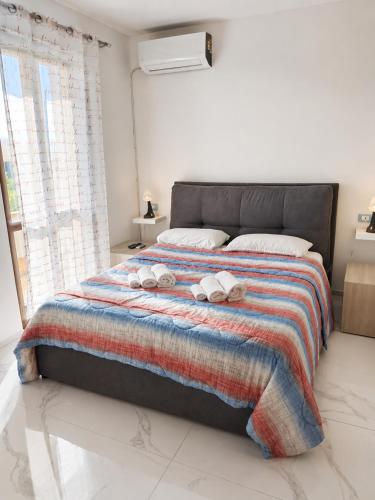 a bedroom with a bed with two towels on it at Once Upon a Time in Centenaro