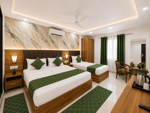 a hotel room with two beds and a desk at Urben BellaMount Hotel - Free Airport and Aerocity Pick Up & Drop in New Delhi