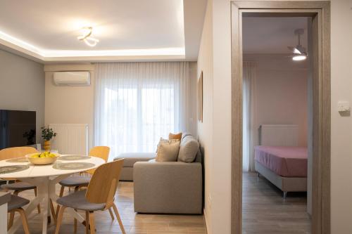 a living room with a couch and a table at Boheme Apartment in Leptokarya