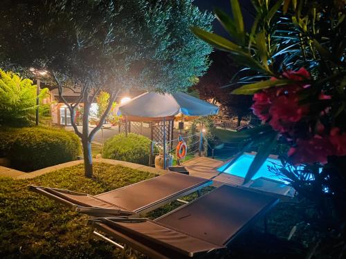 a swimming pool at night with a gazebo at Bed And Breakfast Olimpia in San Salvatore Monferrato