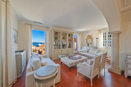a living room with a couch and a table at Hotel la Ponche in Saint-Tropez
