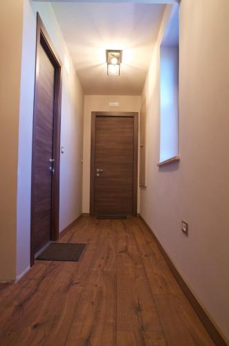 an empty hallway with a wooden door in a house at Casale Rûsignul in Cassegliano