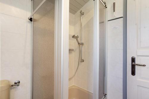 a bathroom with a shower with a glass door at Ferienhaus Hennesee in Meschede