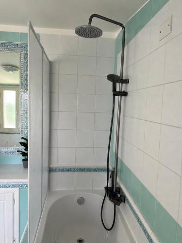 a bathroom with a bath tub with a shower at Laguna Blu Case Vacanza in Carbonia
