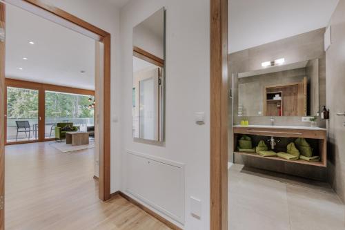 a kitchen with a large glass door leading to a living room at Apartment Waldesruh in Oetz