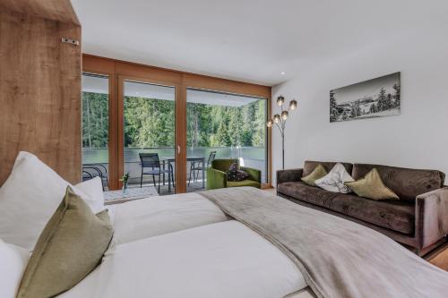 a bedroom with a large bed and a couch at Apartment Waldesruh in Oetz