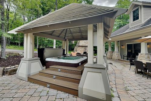 a gazebo with a hot tub on a patio at Stone Mountain Vista in McHenry