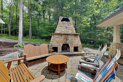 a patio with chairs and a stone fireplace at Stone Mountain Vista in McHenry