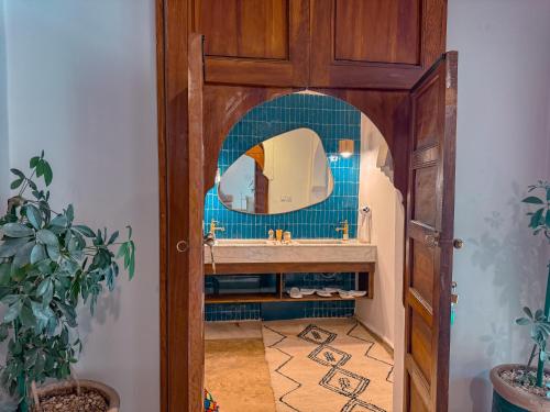 a bathroom with a sink and a mirror at Riad N'S & Spa in Marrakesh