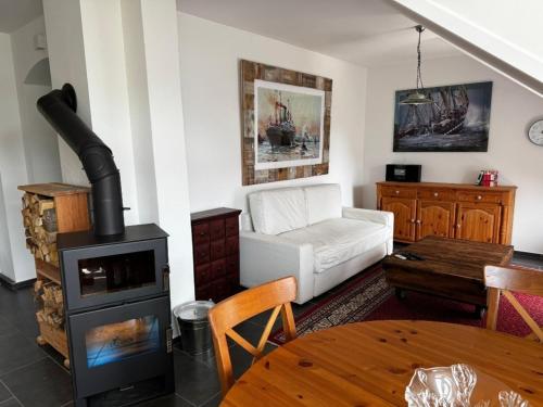 a living room with a wood stove and a couch at Stadtvilla in Kiel