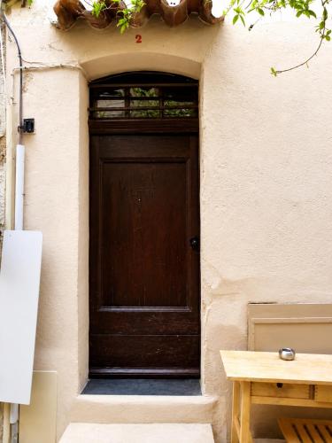 a wooden door in the side of a building at Beautifully Bright Apartment in Old Town Saint-Tropez in Saint-Tropez