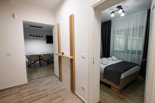 a bedroom with a bed and a dining room at Vila MIHAI in Văliug