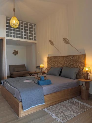 a bedroom with a large bed with a teddy bear on it at Seaview Apartments in Anavyssos