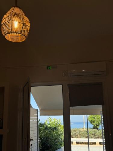 a chandelier hanging from a ceiling in a house at Seaview Apartments in Anavyssos