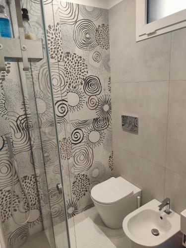 a bathroom with a shower and a toilet and a sink at AnnAmuri in Belpasso
