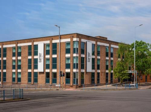 a large brick building with a lot of windows at Garner Hotel Wolverhampton by IHG in Wolverhampton