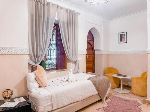 a bedroom with a bed and a window at Riad N'S & Spa in Marrakesh