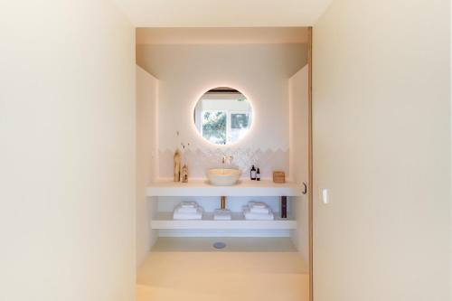 a bathroom with a sink and a mirror at Quinta Amala in Melides