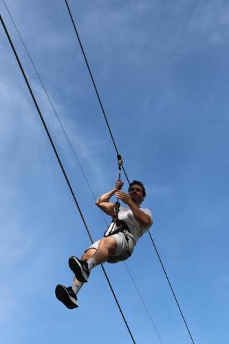 a man is hanging on a zip line at Hotel Villa Batalha in Batalha