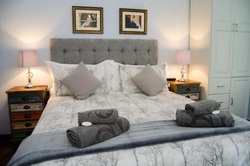a bedroom with a large bed with two pillows on it at Annies House in Cradock