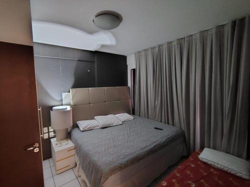 a small bedroom with a bed and a window at Flat 203 Ed Clarice Lispector, Ilhotas- Rio Poty in Teresina