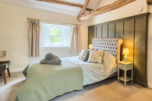 a bedroom with a large bed and a window at 2 Bed in Caldbeck oc-b38644 in Caldbeck