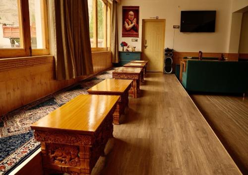 a row of wooden benches in a room at Lavender House in Nubra