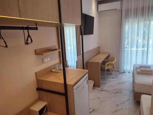 a small room with a kitchen and a bedroom at Estelle Hotel in Gerakini