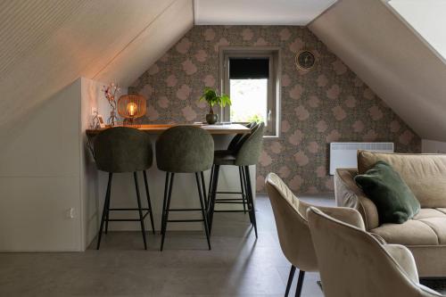 a living room with a table and chairs and a couch at Hannes in Schagen