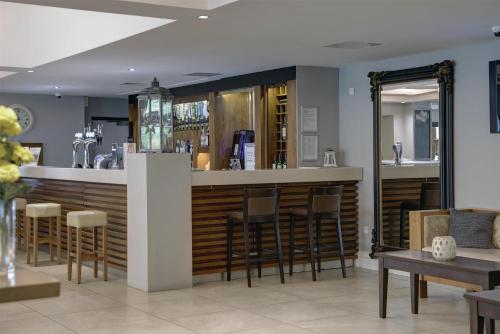 a bar in a restaurant with stools at Best Western Appleby Park Hotel in Tamworth