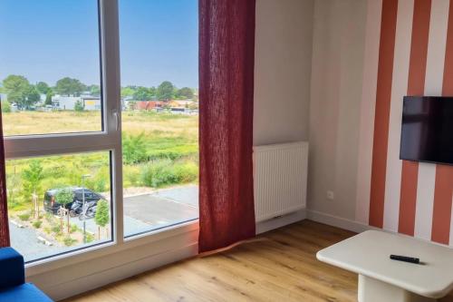 a room with a window with a view of a field at Studio for 2 in La Teste-de-Buch parking in La Teste-de-Buch