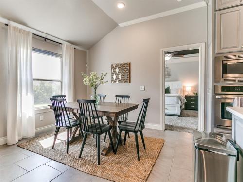 a kitchen and dining room with a table and chairs at Exquisite Escape in Moore! in Moore