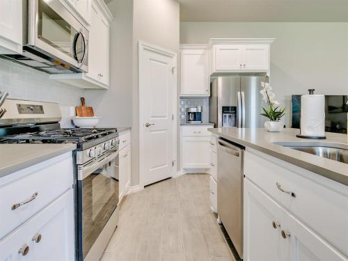 a kitchen with white cabinets and a sink at Oklahoma City's Hidden Gem in Moore