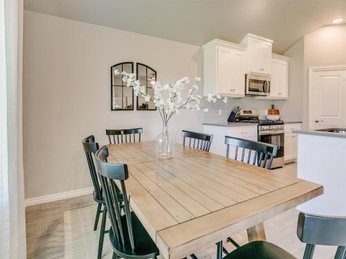 a kitchen and dining room with a wooden table and chairs at Oklahoma City's Hidden Gem in Moore