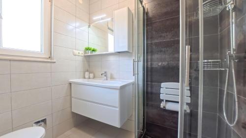 a bathroom with a sink and a shower at CASA di NATALIA, Spacious 2BR Apartment for 6 near Beach ,Free Parking in Kaštela