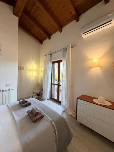 a bedroom with a large bed and a window at VILLA SEASIDE HAVEN - Private Retreat with Garden in Anzio in Anzio