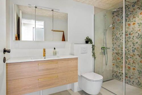 a bathroom with a toilet and a sink and a shower at BL1001-Blokhus-Ferren-95 in Blokhus